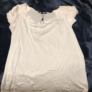Women’s white t with ruffle shoulder line